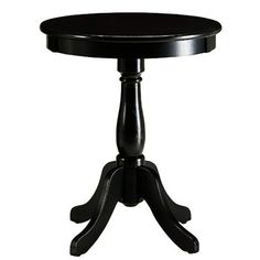 a small black table sitting on top of a white floor