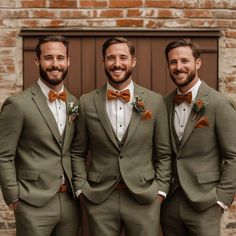 three men wearing suits and bow ties standing next to each other in front of a brick wall