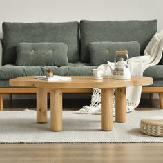 a living room with two couches, a coffee table and a rug on the floor