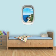 an airplane window with a view of the ocean and beach from it's bedroom