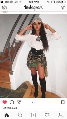 a woman in short shorts and boots posing for the camera with her hand on her head