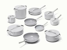 a group of pots and pans sitting next to each other on a white surface