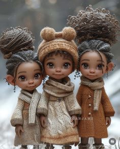 three dolls are standing next to each other wearing winter clothes and scarves on their heads