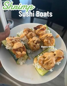 sushi boats on a plate with rice and sauce