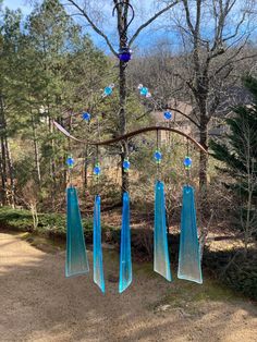 a blue wind chime hanging from a tree