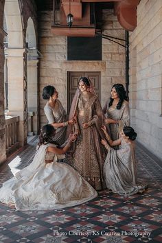 the bride and her three daughters are getting ready to go into their wedding ceremony in india