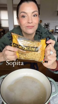 a woman holding up a bag of food in front of her face