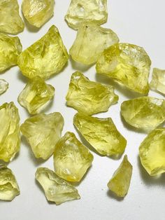 some yellow crystals on a white surface