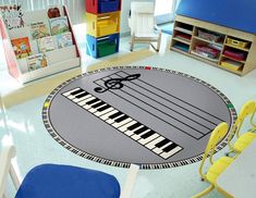 a child's room with a piano rug on the floor and children's chairs