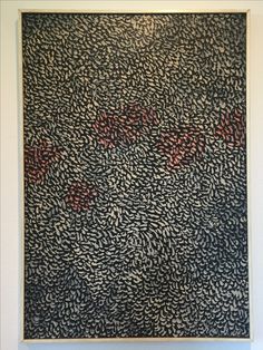 a black and red painting hanging on the wall