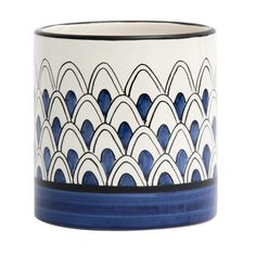 a blue and white vase with wavy lines on it