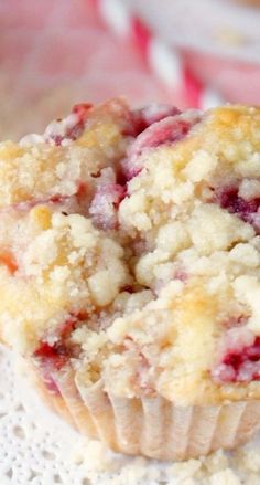 a muffin with crumbs sitting on top of a doily