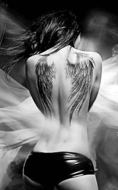 the back of a woman's body with wings on it