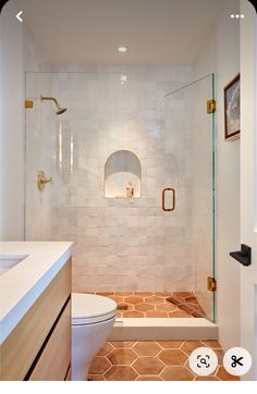 a bathroom with a toilet, sink and shower in it's own area is shown