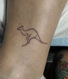 a small kangaroo tattoo on the ankle