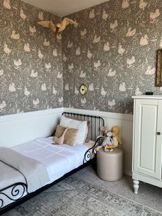 a small child's room with a bed and dresser