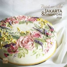 there is a cake decorated with flowers and leaves on the top layer, which reads paint on cake jakrata & singapore 2013