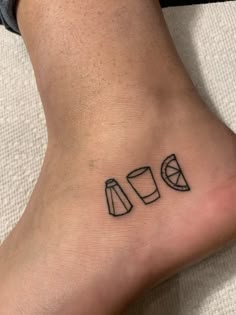 a person with a small tattoo on their foot that has three different shapes and sizes