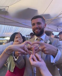 a group of people making a heart shape with their hands