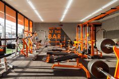 an indoor gym with orange and black equipment