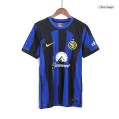 a soccer shirt hanging on a hanger in front of a white wall with the word inter