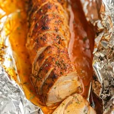 pork loin wrapped in foil with sauce on top