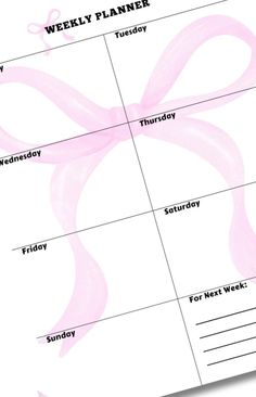 a weekly planner with pink ribbons on it