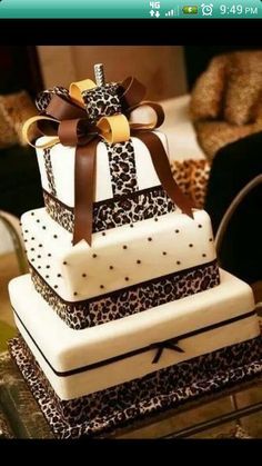 the cake is decorated with leopard print and ribbon