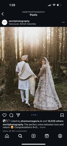 two people standing in the woods holding hands