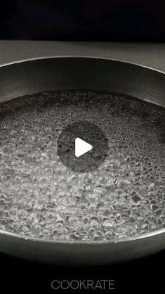 a frying pan filled with water on top of a stove