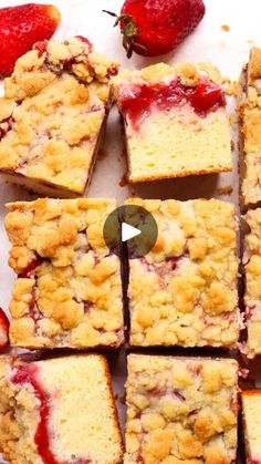 strawberry crumb bars cut into squares on a cutting board