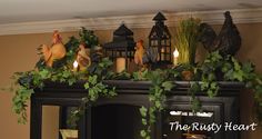 a fireplace decorated with greenery and candles