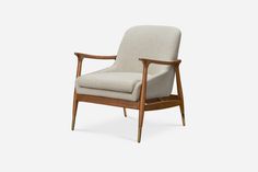 an upholstered chair with wooden legs and arm rests on a white background,