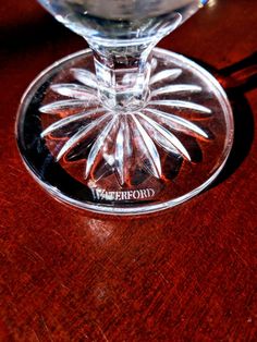 a wine glass sitting on top of a wooden table