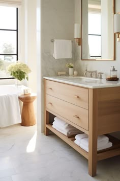 a bathroom with a sink, mirror and bathtub