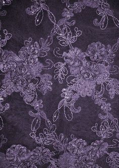 the fabric is purple and has flowers on it, as well as sequins