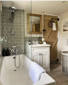 a white bath tub sitting next to a wooden door