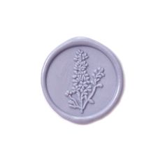 a wax stamp with a flower design on the front and back of it's seal