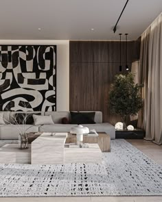 a modern living room with black and white artwork on the wall