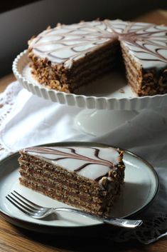 a piece of cake on a plate with a fork next to it and another slice missing