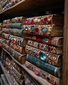 many books are stacked on top of each other in a book case with gold trimmings