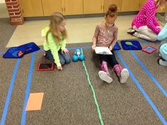 three children sitting on the floor playing with toys