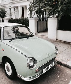 an old car is parked on the side of the street