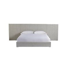 a bed with white sheets and pillows in front of a wall mounted headboard that has vertical slats on it