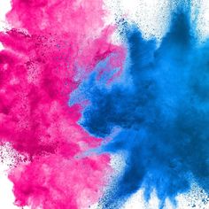 blue and pink powder are mixed together on a white background