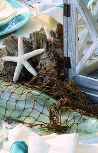 the table is set with starfish and shells