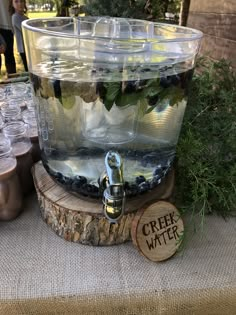 a water dispenser filled with blueberries on top of a table