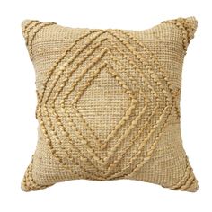 a beige pillow with braiding on the front and back, against a white background