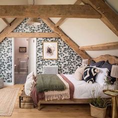 a bedroom with wood beams and green wallpaper