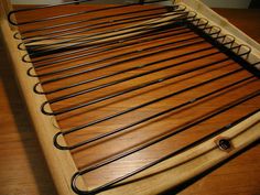 a close up of a bed frame with wooden slats and metal bars on it